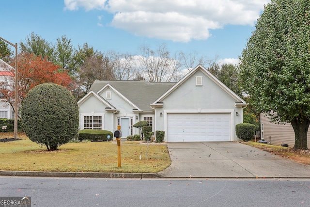 single story home featuring a garage and a front lawn