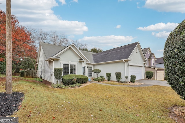 view of front of home with a garage and a front lawn