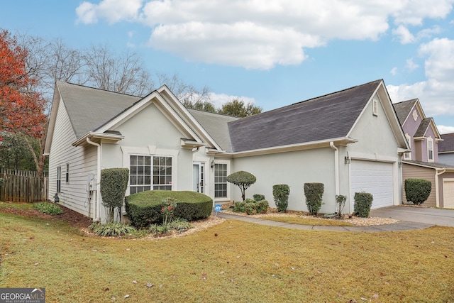 view of front of house with a front yard and a garage