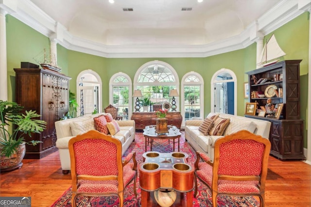 sunroom with a tray ceiling and ornate columns