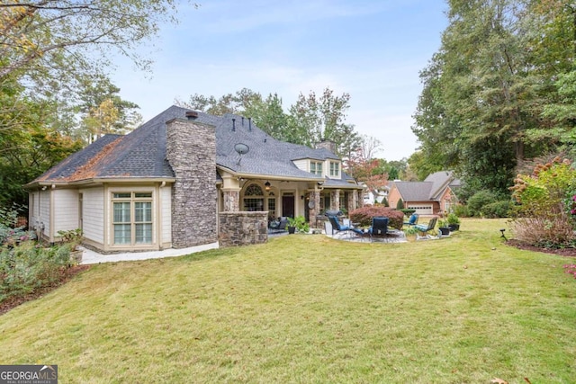 back of house featuring a yard and a patio area