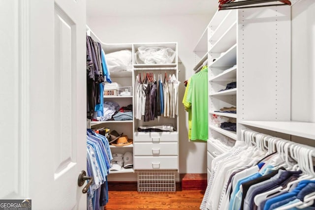 walk in closet featuring dark hardwood / wood-style flooring