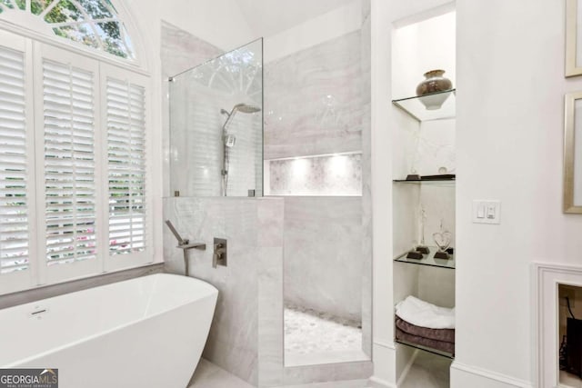 bathroom featuring separate shower and tub and plenty of natural light