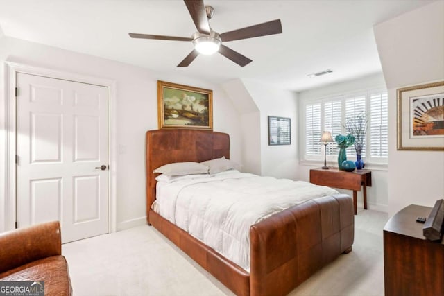 bedroom featuring light colored carpet and ceiling fan