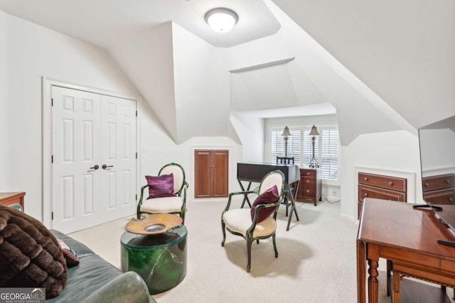 living area featuring lofted ceiling and light carpet