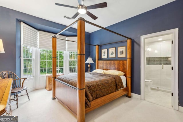 carpeted bedroom featuring ceiling fan and ensuite bathroom