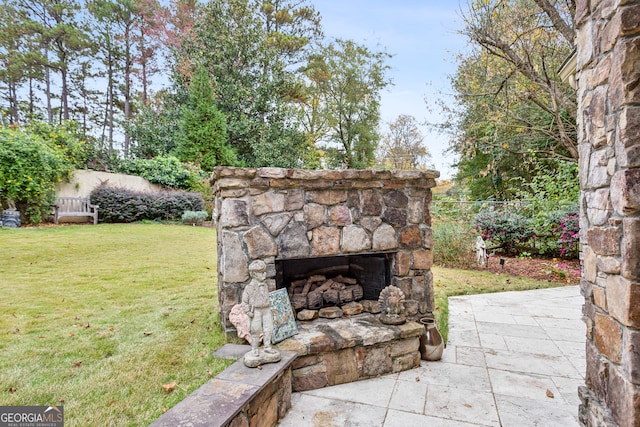 view of patio featuring an outdoor stone fireplace