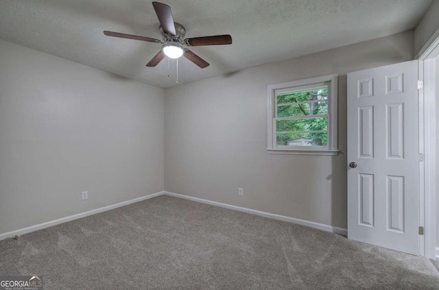 carpeted empty room featuring ceiling fan and a textured ceiling