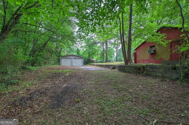 view of yard with a garage and an outdoor structure