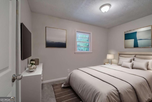 carpeted bedroom with a textured ceiling