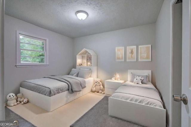 bedroom featuring carpet and a textured ceiling