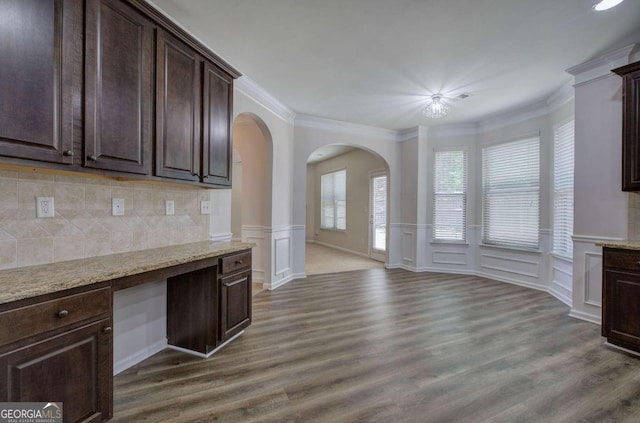 kitchen featuring backsplash, dark brown cabinets, and dark hardwood / wood-style floors