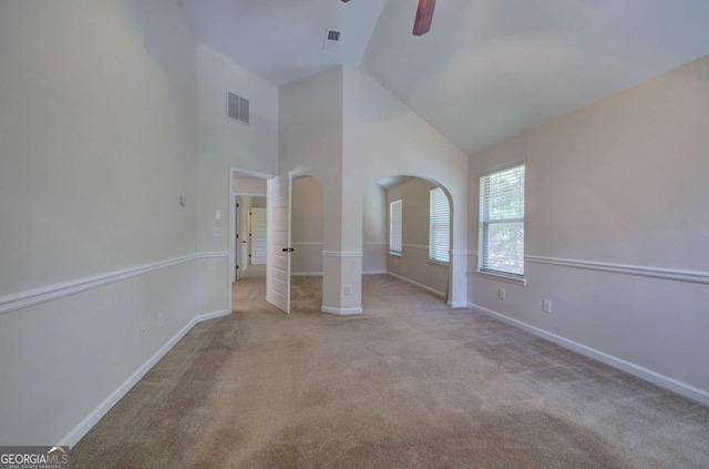 unfurnished bedroom featuring high vaulted ceiling, light carpet, and ceiling fan