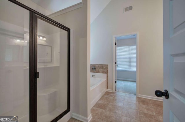 bathroom with lofted ceiling, tile patterned floors, and independent shower and bath