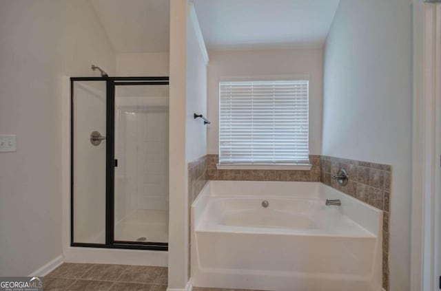 bathroom featuring tile patterned flooring and shower with separate bathtub