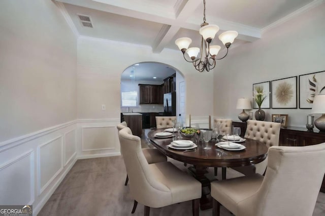 dining space featuring beamed ceiling, coffered ceiling, a notable chandelier, and ornamental molding