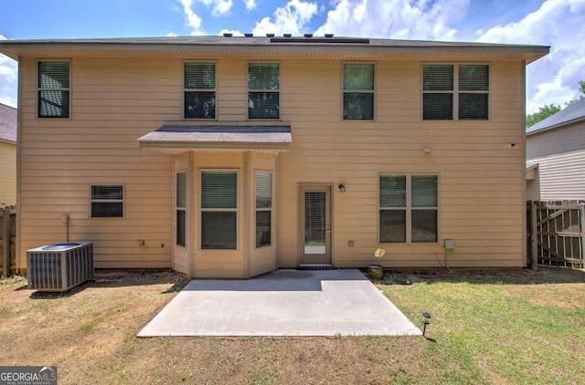 rear view of property featuring a patio and a lawn