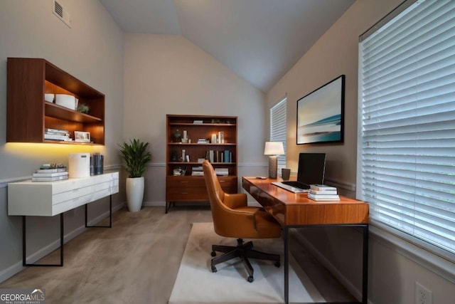 carpeted office with vaulted ceiling