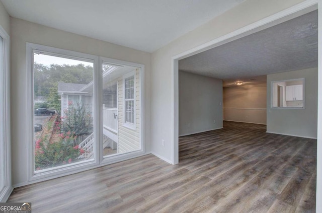 unfurnished room with wood-type flooring