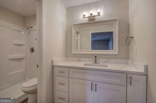 bathroom with toilet, a shower, vanity, and a textured ceiling