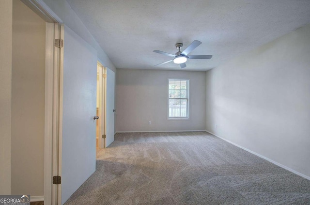 carpeted empty room with a textured ceiling and ceiling fan