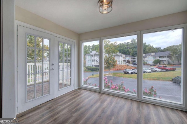 unfurnished sunroom with a wealth of natural light and french doors