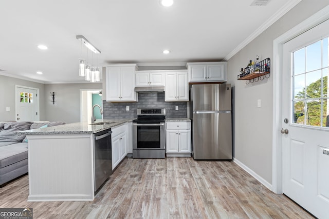 kitchen featuring kitchen peninsula, white cabinetry, appliances with stainless steel finishes, and pendant lighting