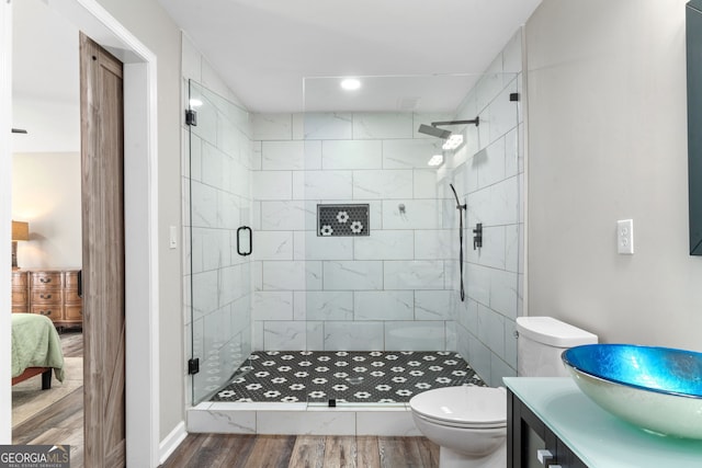 bathroom featuring vanity, an enclosed shower, toilet, and hardwood / wood-style flooring