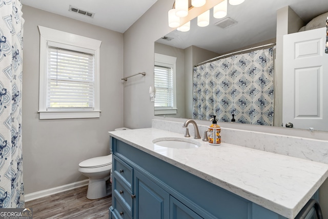 bathroom featuring hardwood / wood-style floors, vanity, and toilet