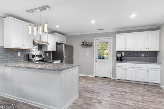 kitchen with appliances with stainless steel finishes, light wood-type flooring, ornamental molding, decorative light fixtures, and white cabinetry