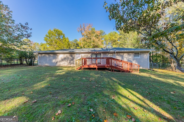 back of house featuring a yard and a deck