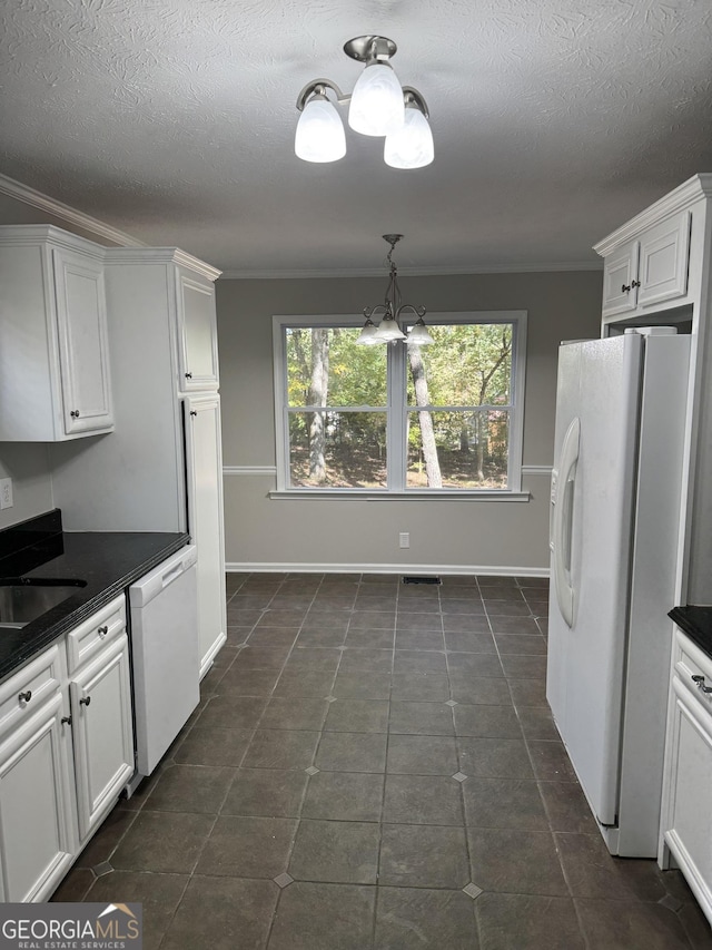 kitchen featuring sink, white cabinets, ornamental molding, white appliances, and an inviting chandelier