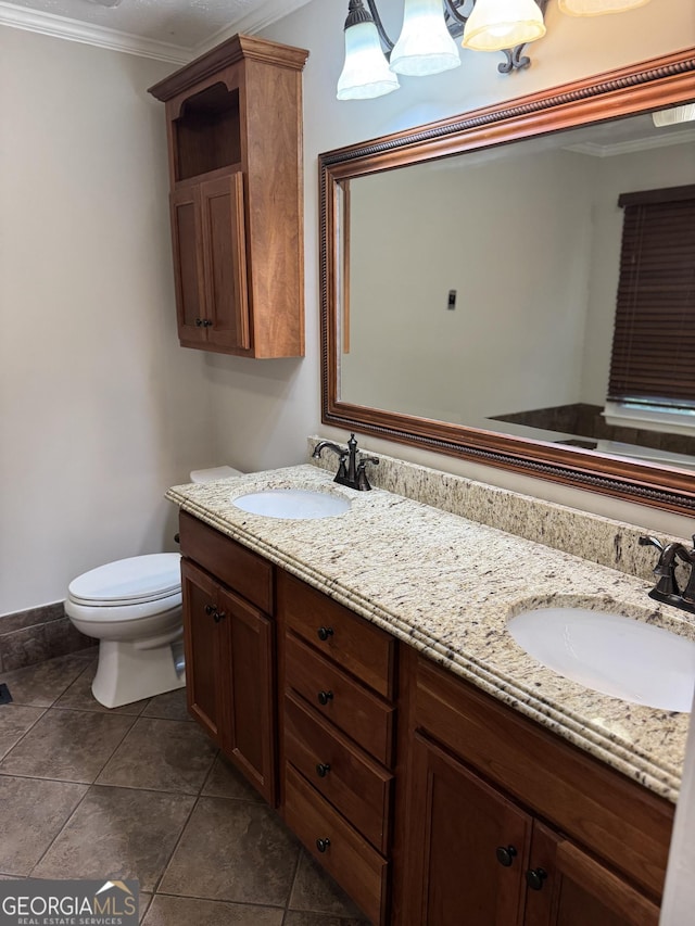 bathroom featuring tile patterned flooring, ornamental molding, vanity, and toilet