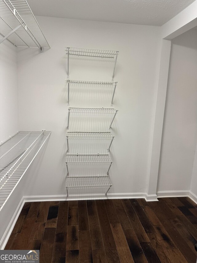 laundry area with electric dryer hookup, washer hookup, and hardwood / wood-style flooring