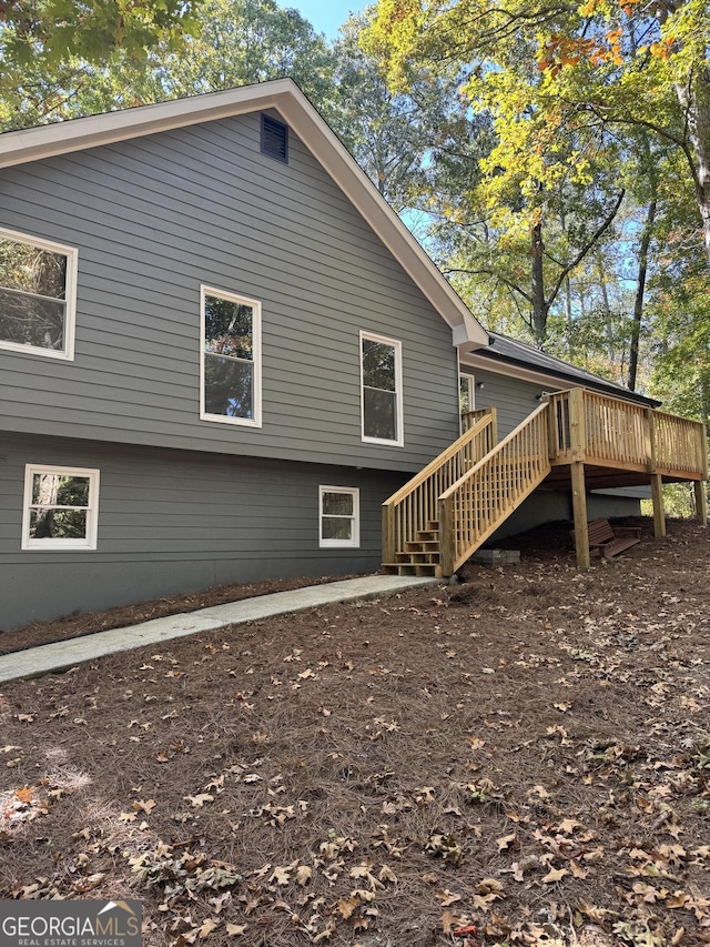 rear view of house featuring a deck