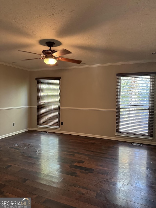 unfurnished room with ornamental molding, a textured ceiling, and dark hardwood / wood-style flooring