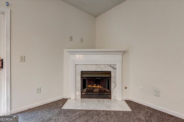 room details featuring a fireplace and carpet floors