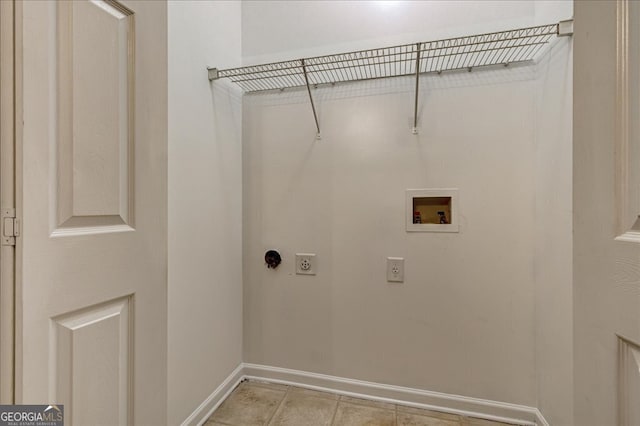 clothes washing area with light tile patterned floors, hookup for a washing machine, and hookup for an electric dryer