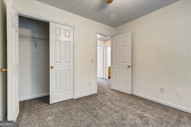 unfurnished bedroom with carpet floors, a textured ceiling, ceiling fan, and a closet