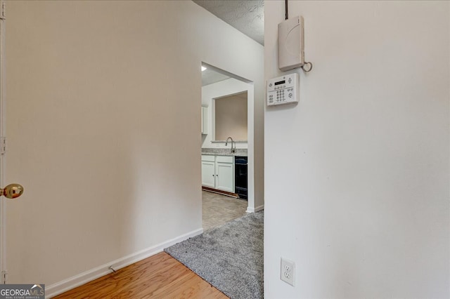 hall featuring sink and light hardwood / wood-style flooring