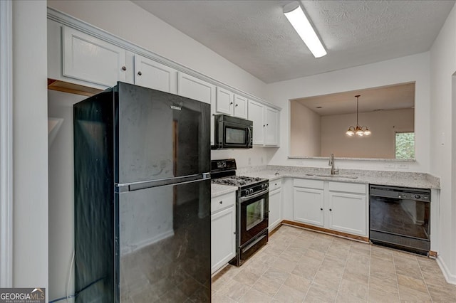 kitchen with white cabinets, sink, black appliances, and decorative light fixtures