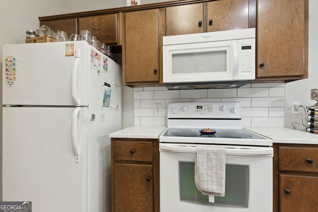 kitchen with white appliances and tasteful backsplash