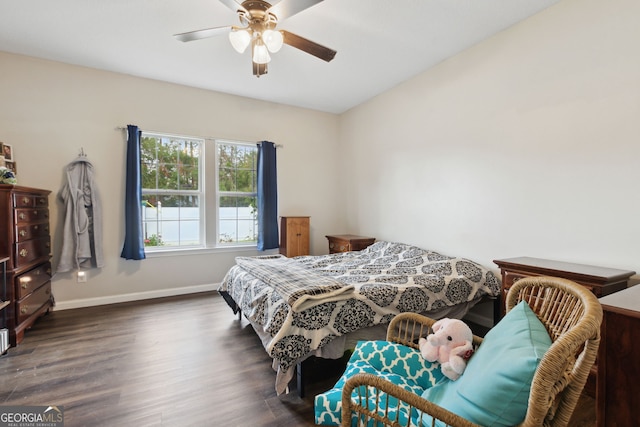 bedroom with dark wood-type flooring and ceiling fan