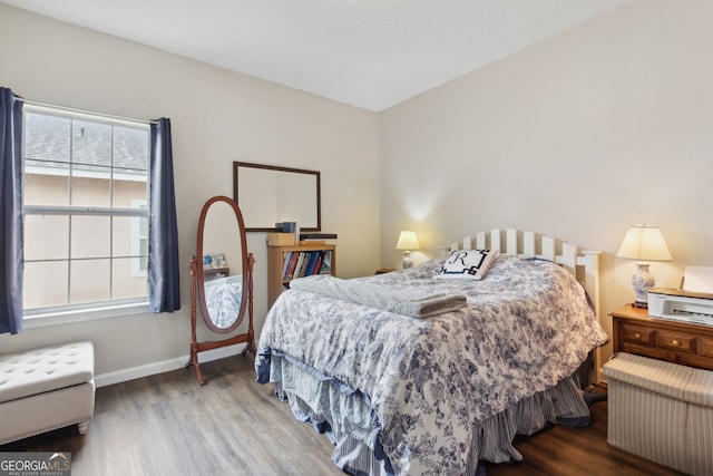 bedroom with hardwood / wood-style flooring