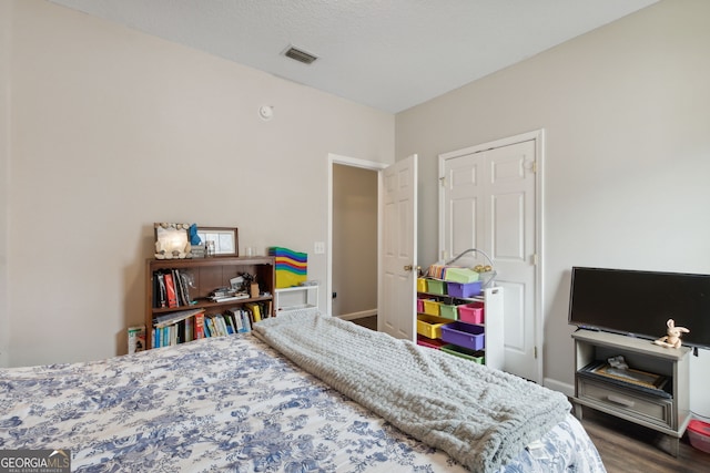 bedroom with hardwood / wood-style floors