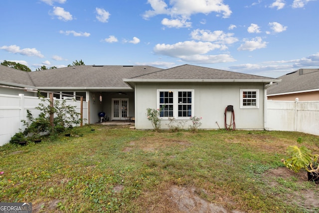 rear view of property with a lawn