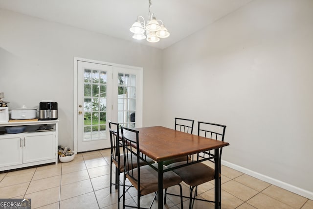 tiled dining area with a chandelier