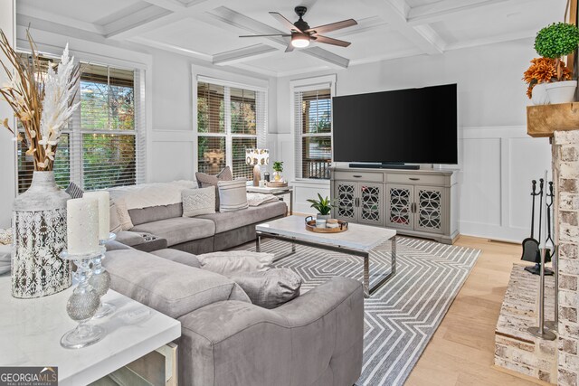 living room with beam ceiling, ceiling fan, light hardwood / wood-style floors, and coffered ceiling