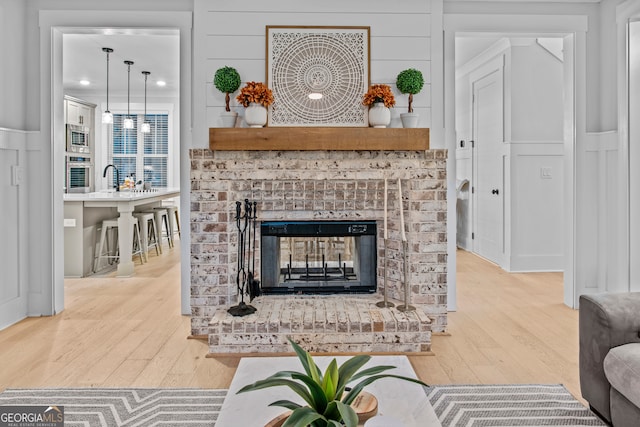 living room featuring a fireplace and wood-type flooring