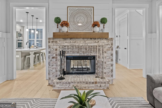 265 Federal St, Athens, GA 30607 - living area featuring hardwood / wood-style floors, a decorative wall, and a fireplace